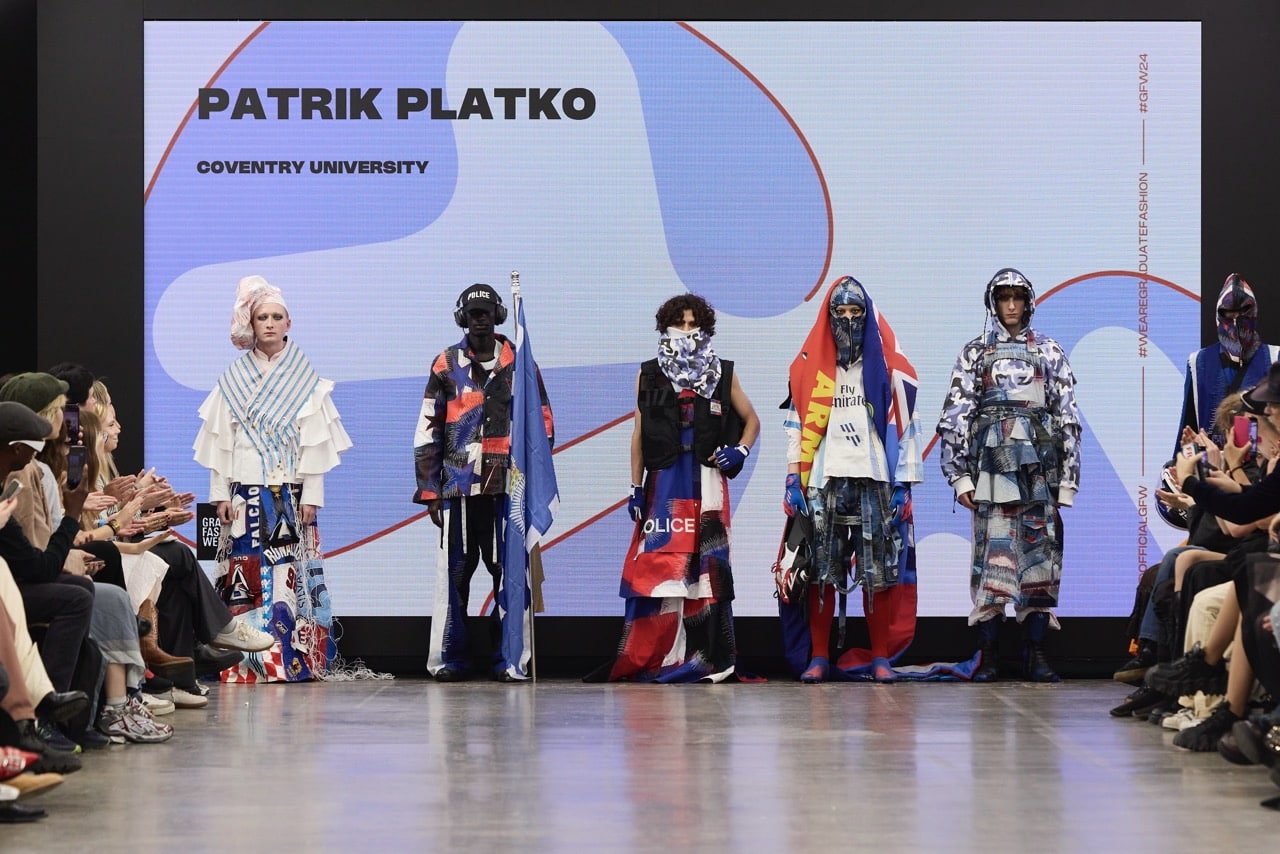 Five models strut down the runway showcasing diverse outfits by Patrik Platko from Coventry University, captivating the audience on both sides at Graduate Fashion Week 2024 (GFW).